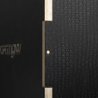 Close-up side of black wooden jump box with light wood frame and brass dots