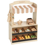 Kids wooden play shop with striped awning, cash register, and shelves of toy groceries