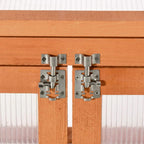 Metal latch hardware on a wood greenhouse cold frame door frame