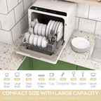 White countertop dishwasher with open door showing stacked plates and utensil rack