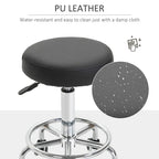 Black PU-style round padded stool seat with chrome base and caster wheels