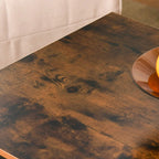 Rustic brown tabletop with visible wood grain on an industrial coffee table