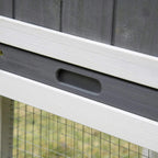 Close-up of white slide-out tray handle under the small animal hutch