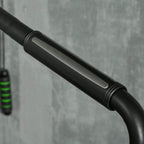 Black curved handlebar grip on a white stair stepper machine.