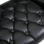 Close-up of black tufted PU leather upholstery on a swivel bar stool