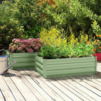 Set of two light green steel raised planter boxes with mixed flowers on a deck