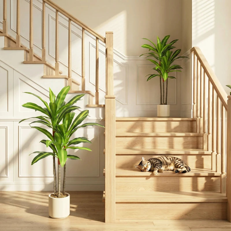 Green artificial dracaena tree with multiple stalk trunks in a white planter pot.