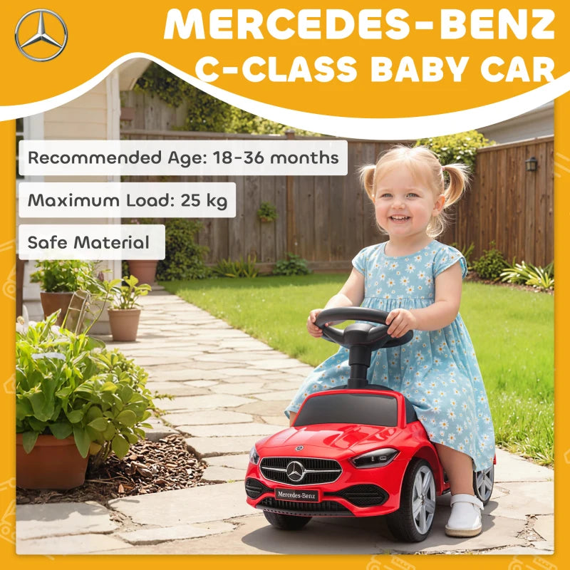 Red Mercedes-Benz ride-on car with child riding, black seat and steering wheel