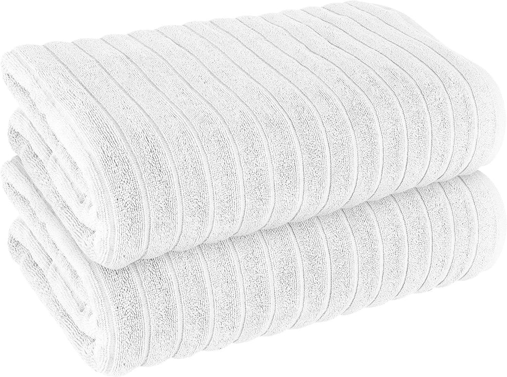 White ribbed bath sheet towel stack, rolled texture detail