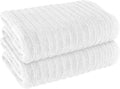White ribbed bath sheet towel stack, rolled texture detail