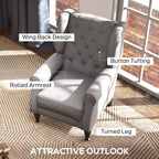 Light grey wingback armchair with button tufting, rolled arms, and turned legs