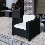 Black outdoor armchair with woven rattan frame and thick white padded seat cushion