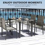 Outdoor dining table with tempered-glass top and 4 grey woven chairs in rows