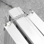 Silver aluminum folding wheelchair ramp with attached security chain and ring handles
