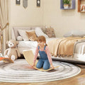 Orange wooden wobble balance board with curved rocker, kids using it for balance