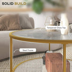 Close-up of gold-tone steel frame round coffee table with tempered glass top and open lower shelf