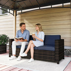 Outdoor rattan sofa with dark blue backrest and woven armrest side panel