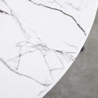 White marble-look tabletop with dark veining on round bistro table