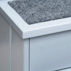 Gray carpeted top step on pet stairs with smooth light wood frame