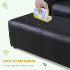 Black ottoman footstool with wipe-clean surface, hand holding a cloth