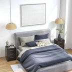 Dark nightstand with three drawers and curved metal bar handles, flat top surface.