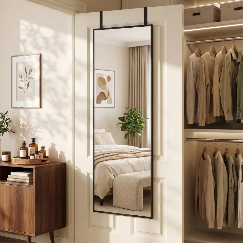 Black full-length rectangular mirror reflecting a bedroom doorway