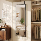 Black full-length rectangular mirror reflecting a bedroom doorway