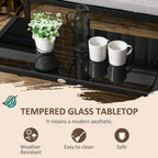Tempered glass tabletop on dark metal coffee table with decorative items