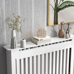 White radiator cover cabinet with top shelf displaying decor and vertical slat grill