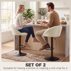 Set of 2 cream counter stools with curved backs and black swivel bases