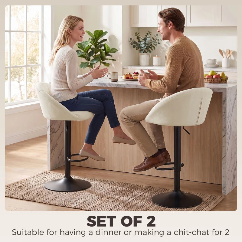 Set of 2 cream counter stools with curved backs and black swivel bases