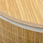 Close-up of bamboo laundry hamper rim with white fabric lining edge and stitched seam.