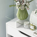 Tempered glass top on a white shoe storage cabinet with raised shelf edge