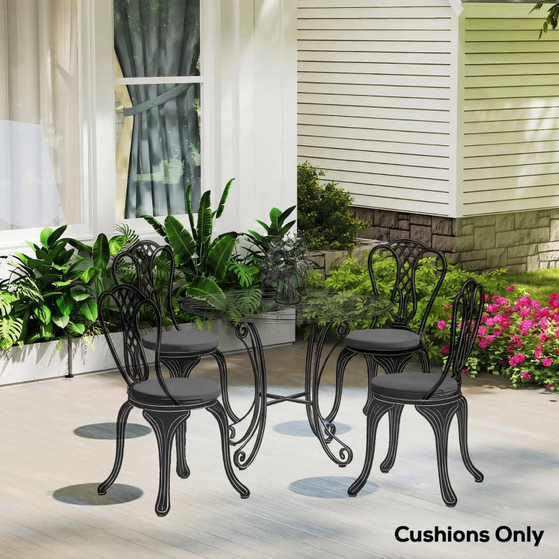 Multiple outdoor chairs showing dark grey round seat cushions with tie fasteners