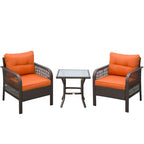 Rattan bistro set with glass-top table and two orange-cushioned armchairs