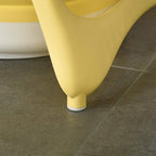 Yellow bathtub support leg with white non-slip foot, close-up