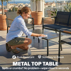 Grey loveseat seating and metal table with dark tabletop for patio use