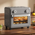 Grey mini air fryer oven with closed front door window, cooking inside on shelves