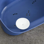 Blue baby bathtub base with drain hole cover and small safety grip bumps