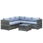Grey rattan corner sofa set with light-blue cushions and matching glass-top coffee table