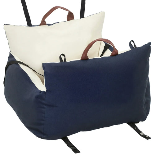 Navy dog car booster seat with cream lining, carry handle, and adjustable safety straps
