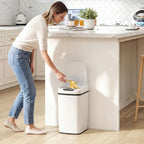 White automatic motion sensor kitchen bin at kitchen counter with open lid