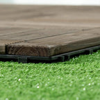 Close-up of charcoal grey decking tile top slats and black raised support feet