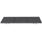 Grey tri-fold gymnastics crash mat with three hinged sections and end handles