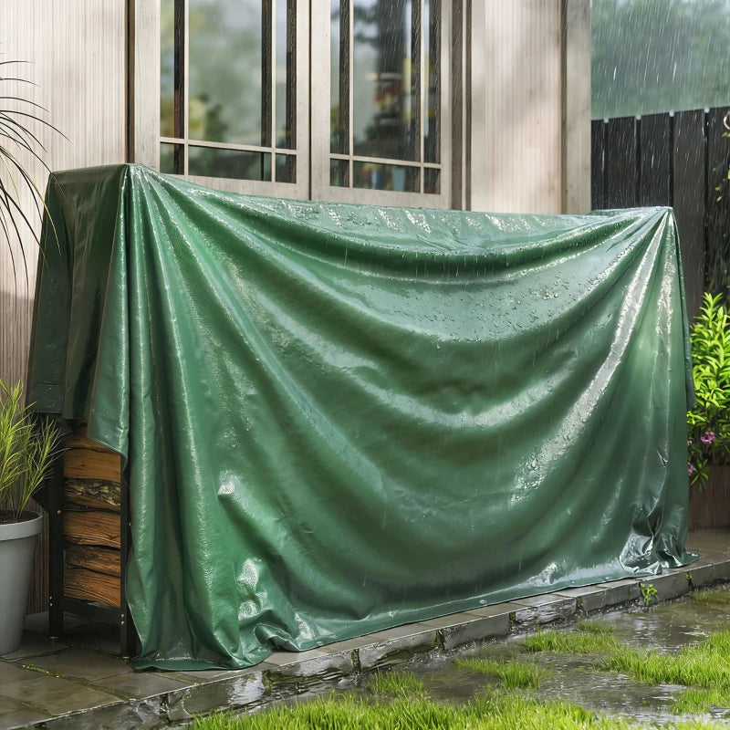 Green waterproof PE tarpaulin cover draped over equipment near a building