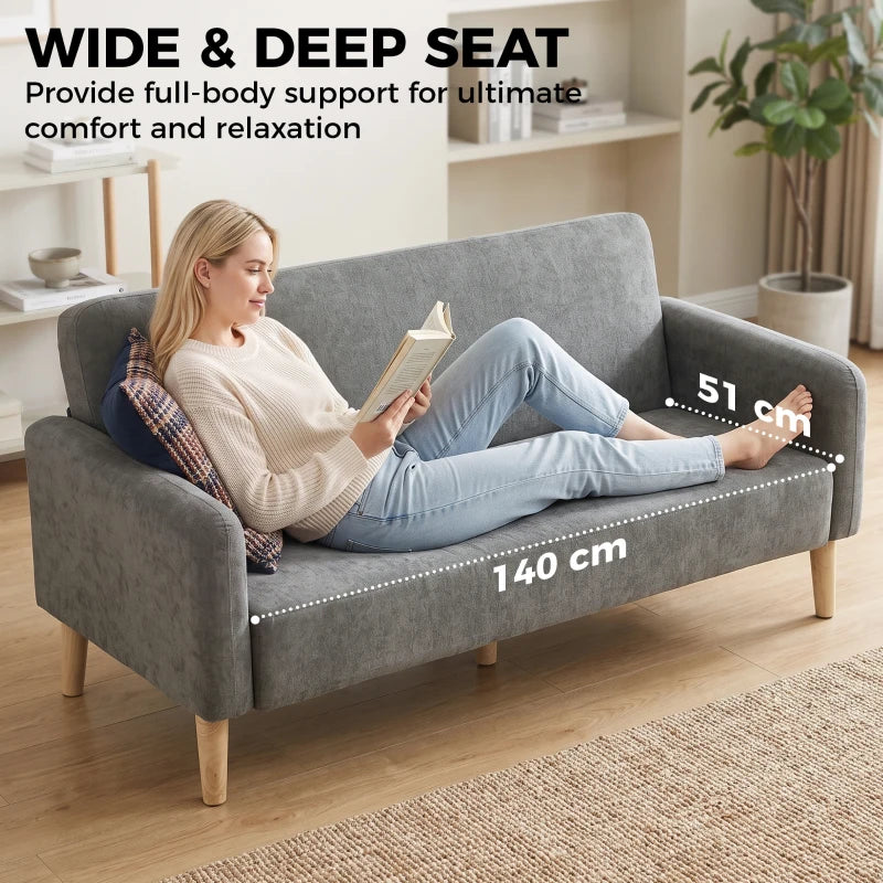 Grey velvet 2-seater sofa with wide seat, thick padding, and light wood legs
