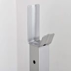 Silver safety arm bracket with adjustment hole on squat rack upright post.
