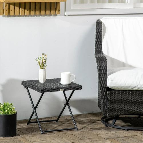 Black square folding table with woven wicker top and X-frame legs