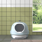 Blue enclosed cat litter box viewed from front with circular entry and top handle