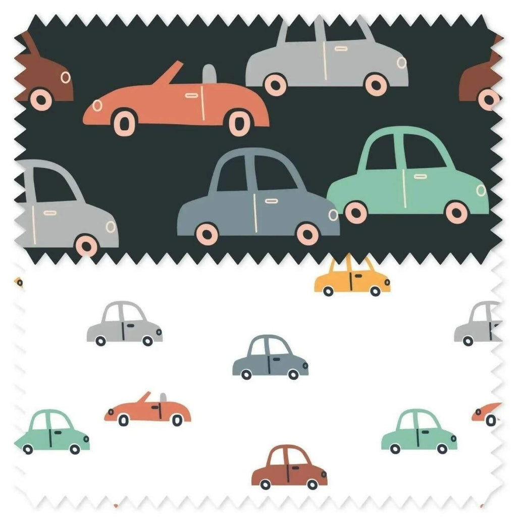 Vehicle-print upholstery fabric swatches with multi-color cars on a dark background